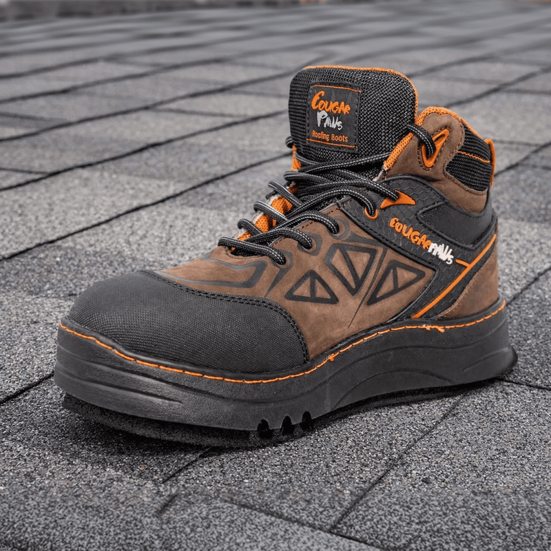Cougar Paws roofing boot with a replaceable foam pad standing on an asphalt shingle roof